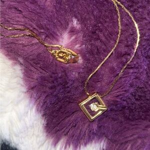 Elegant Gold GIVENCHY Necklace with Pendant and small diamond accent.